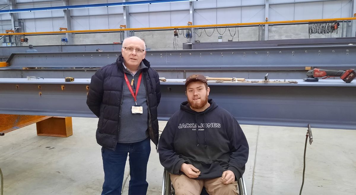 Student in wheelchair with tutor in engineering workshop